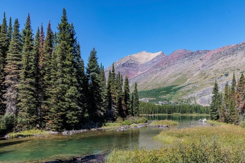 240831_301 Rugged Mountains rise up behind the south end of Swiftcurrent lake in Glacier National
