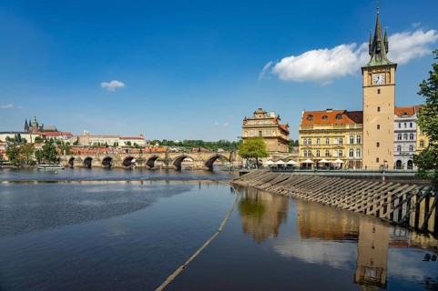 Vltava embankment with Old Town Water Tower, Novotný Bridge and Charles Bridge in Prague, Czech