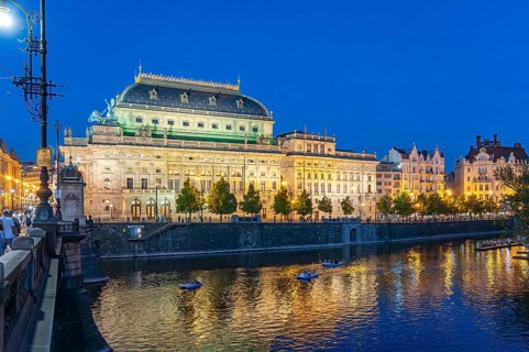Vltava embankment with the Academy of Arts, Architecture and Design at dusk, Prague, Czech Republic