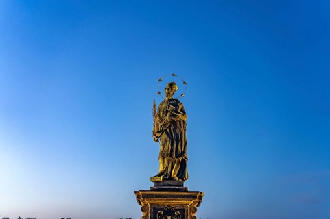Saint John Nepomuk on Charles Bridge at dusk, Prague, Czech Republic
