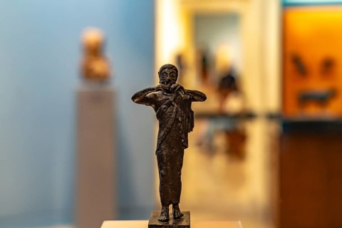 Bronze miniature of a flute player in the Archaeological Museum of Delphi, UNESCO World Heritage