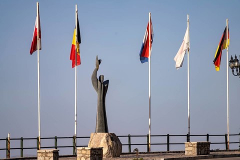Stylized Prometheus sculpture and flag gallery in modern Delphi, Greece
