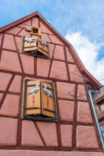 Timbered house with storks as decoration in Riquewihr, Alsace