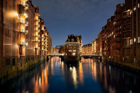 Night view, historic moated castle, warehouses, brick buildings, canal, Hamburger Speicherstadt,