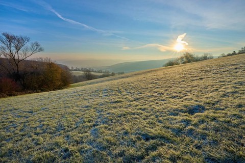 Soft sunlight and frost over a range of hills on a clear morning, Seckmauern, Lützelbach, Maintal,
