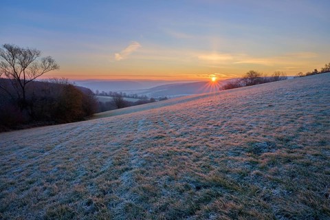 A frosty morning with sunrise over a rolling landscape, Seckmauern, Lützelbach, Maintal, Odenwald,