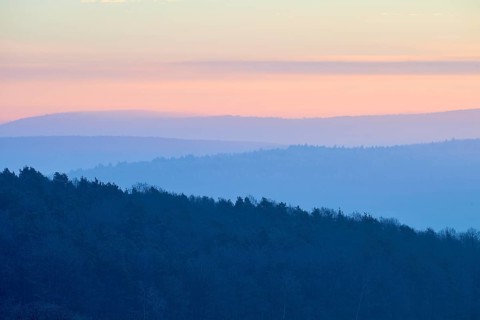 Shady hills and a calm pastel sky at sunset create a quiet atmosphere, Seckmauern, Lützelbach,
