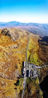 Autumn colours of Pen-y-Pass over Miner's Track, Start Point and road A4086 from a drone,