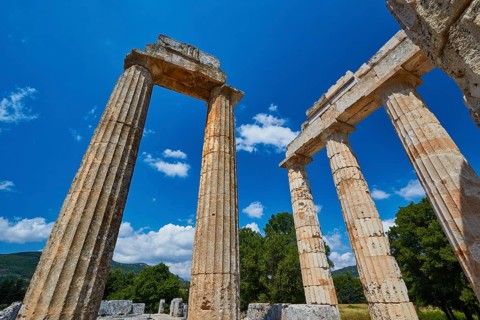 Well-preserved ancient columns in a landscape with trees, Nemea, Ancient Zeus Heightum,