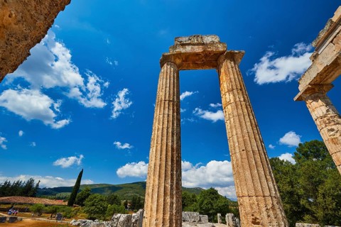 Ancient ruins stand imposing against a clear blue sky with some clouds, Nemea, Ancient Zeus Church,