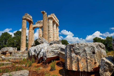 Ancient ruins and pillars under a cloudy blue sky, Nemea, Ancient Zeus Heightum, Archaeological