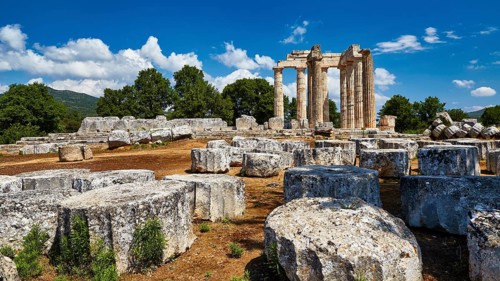 Stone ruins with ancient columns against a blue sky and clouds, Nemea, Ancient Zeus Heightum,