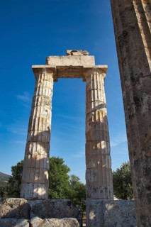 Single antique column with clear sky in the background. Greek Ruins, Nemea, Ancient Zeus Heightum,