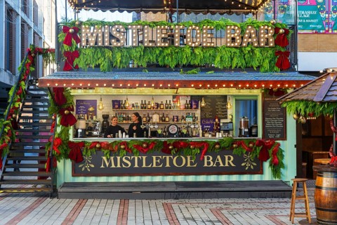 Mistletoe Bar Christmas market wooden shed market stall in city centre, Exeter, Devon, England, UK