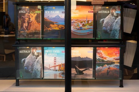 Trailfinders travel agency window display posters, Exeter city centre, Devon, England, UK
