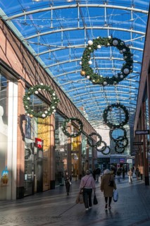 Christmas shoppers inside covered shopping street, Princesshay shopping centre, Exeter, Devon,
