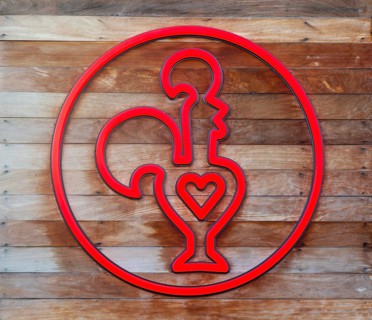 Nando's fast-food restauarnt logo symbol red cockerel heart, Exeter, Devon, England, Uk