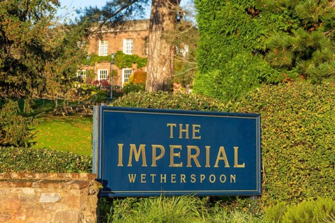 Sign in garden of The Imperial Wetherspoon pub, Exeter, Devon, England, UK