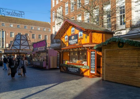 Christmas market wooden shed market stalls in city centre, Exeter, Devon, England, UK - Yorkshire