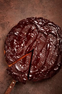 Chocolate cake, round cake, on a brown background, top view, homemade cakes, no people
