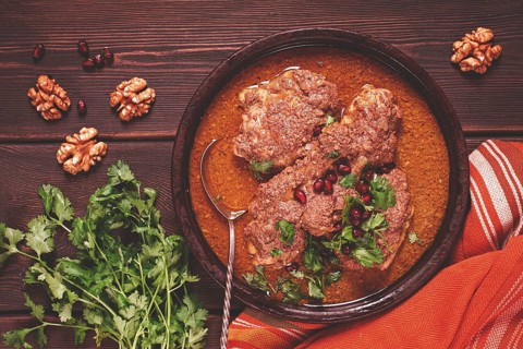 Fesenjan, an Iranian dish, stewed chicken, in walnut-pomegranate sauce, in an earthen pan,
