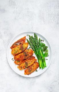 Fried fish fillet, tilapia with asparagus, homemade, no people