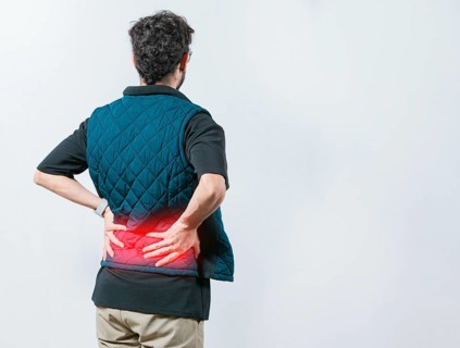Lumbar problems. Suffering male with pain holding his back isolated. Person with spine problems.