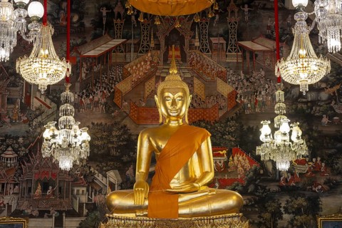 Golden Buddha statue, Phra Buddha Trilokachet surrounded by crystal chandeliers and exquisite wall
