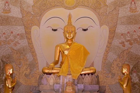 Golden Buddha statue with tunic, Bhumispara mudra, Buddha Gautama at the moment of enlightenment,