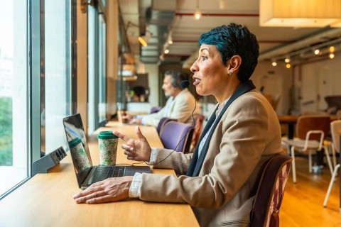 Professional businesswoman engaging in a video call and remote work, actively communicating with a