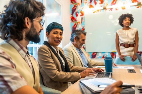 Diverse group of business colleagues meeting and collaborating in a modern office, sharing ideas