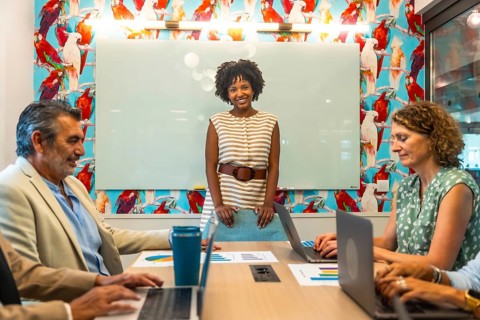 Diverse business team collaborating in a vibrant coworking space, discussing data charts and
