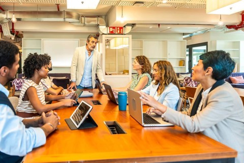 Diverse business professionals conducting a collaborative meeting in a contemporary open plan