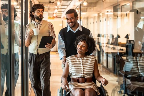 Diverse business colleagues collaborating in a inclusive modern office, a smiling woman in a