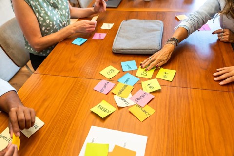 Colleagues collaborating during a business meeting, organizing concepts and strategies with