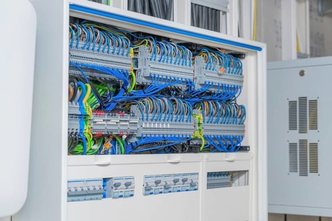 Cable management system with lots of colorful cables in a control box