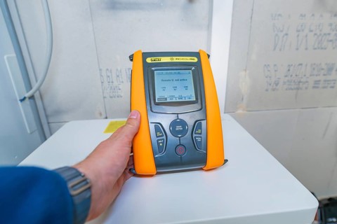 Person operates PVCheck PRO with a display that shows information