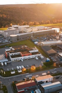 Aerial view of a building complex and industrial areas in autumn surroundings at sunset, new