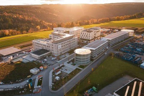 Aerial view of a modern building complex in rural area at sunset, new hospital, Calw Health Campus,
