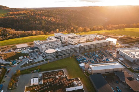 Aerial view of a large complex of buildings in autumn landscape at sunset, new hospital, Calw
