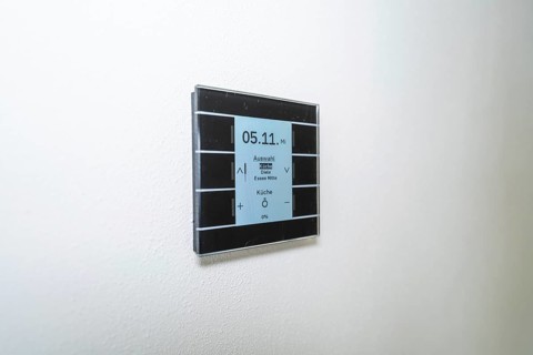 A switch with a display on a white wall