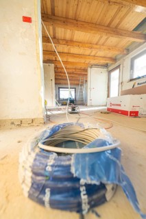 Cable reel and electrical material in a spacious attic during renovation work