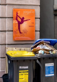 Overfilled trash cans at the entrance to a yoga school, Fulda, Hesse, Germany