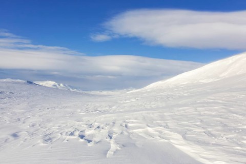 Desolate windswept snow covered Arctic landscape at Mohnbukta, bay at the western shore of