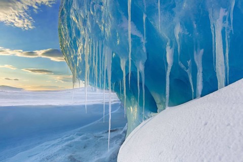 Melting icicles in snow covered Arctic landscape at Mohnbukta, bay at the western shore of