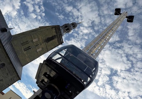View from bottom to top of the Look 360 degree mobile skylift and of St. Peter's Church, All Saints