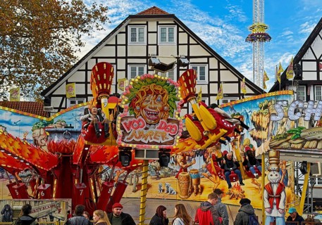 All Saints Fair ride in front of half-timbered houses, largest old town fair in Europe, Soest,
