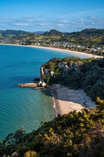 Landscape with sea and sandy beach in New Zealand. View of Lonely Bay and Cooks Beach from