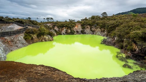 Roto Karikitea, a crater in the Waiotapu (Wai-O-Tapu) geothermal area, filled with green water from