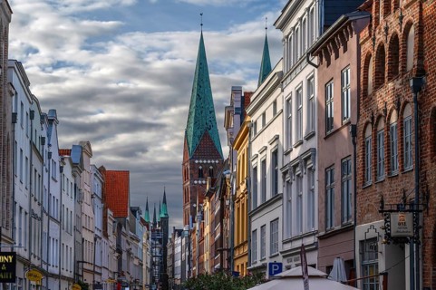 Shopping street with historic houses and the towers of St. Mary's Church, Hanseatic City of Lübeck,